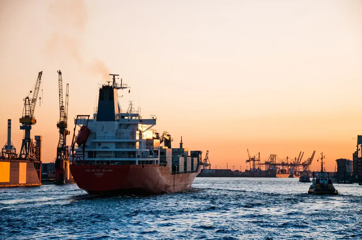 Container cargo ship at sunset harbor